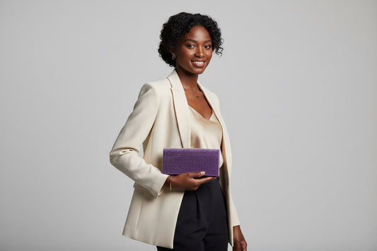 Purple glittery rectangular clutch on a white background